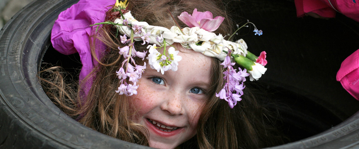 girl in tyre wearing flower crown